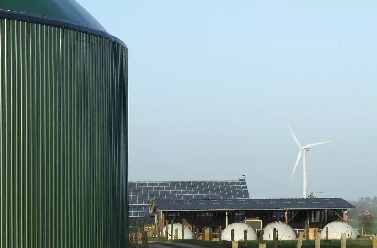 Farm with a biogas digester, rooftop solar panels and a wind turbine
