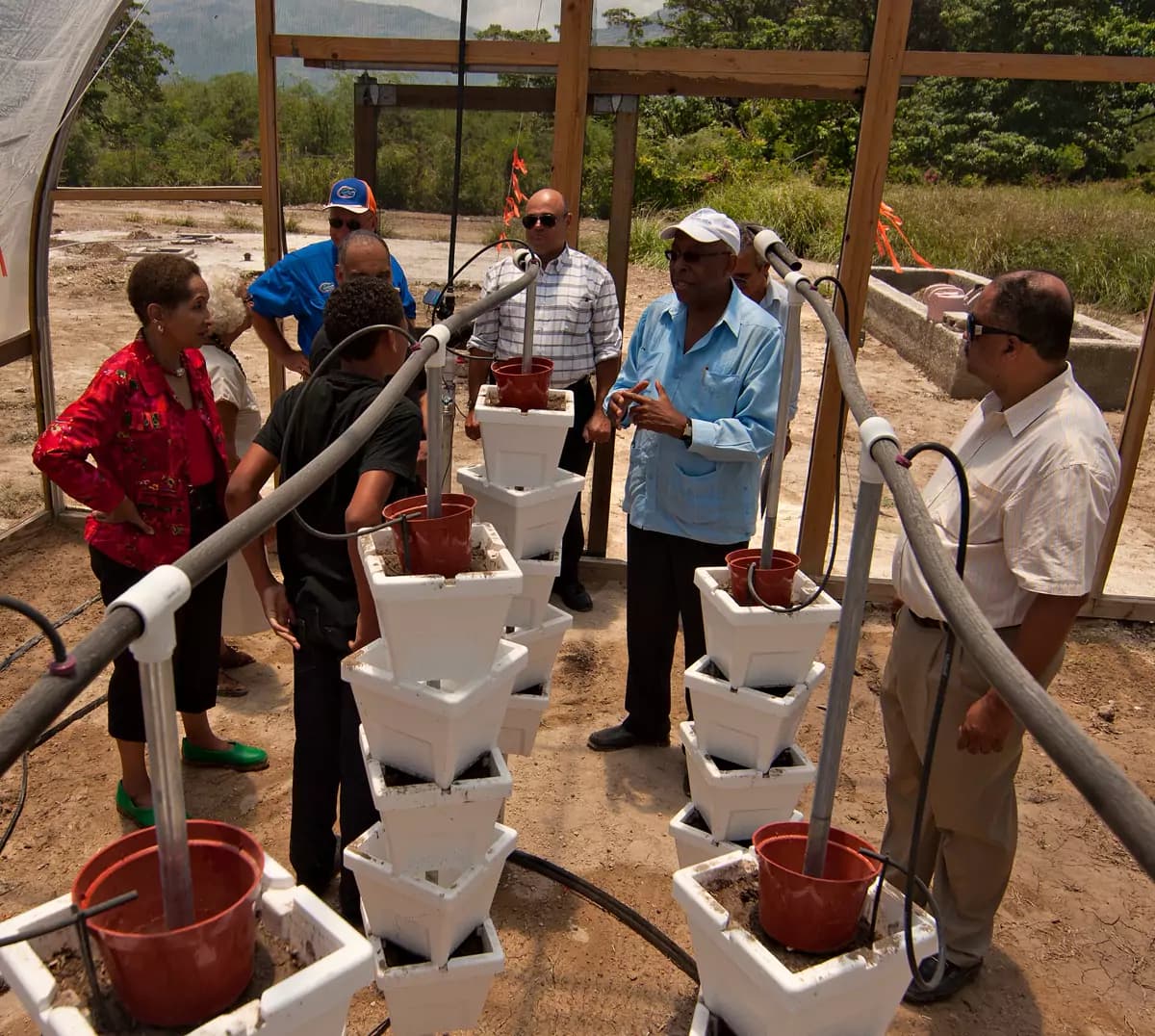 Farmers looking at drip-irrigated tower gardens during a field demonstration