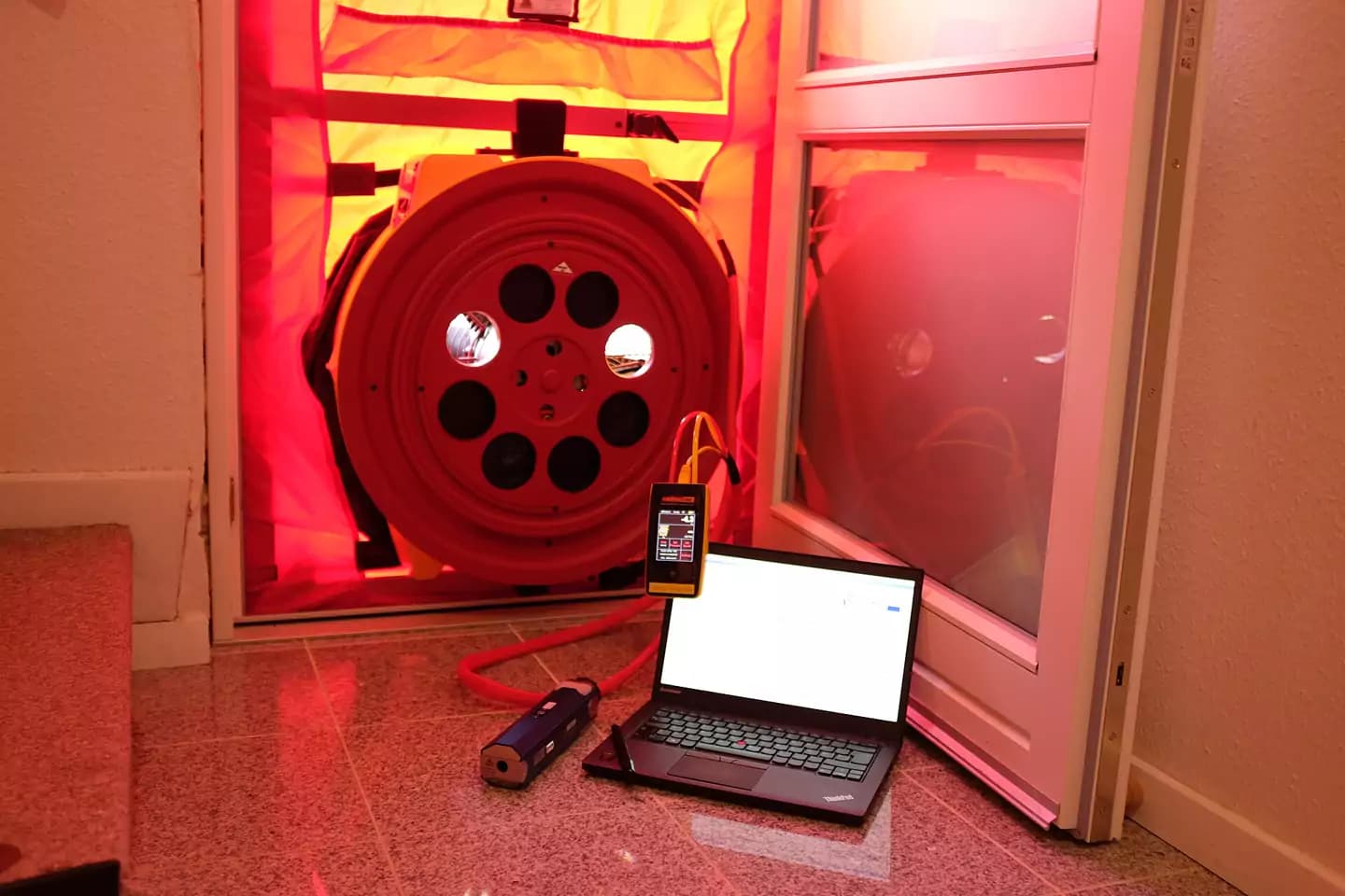 Blower-door fan fitted in a doorway for an airtightness test